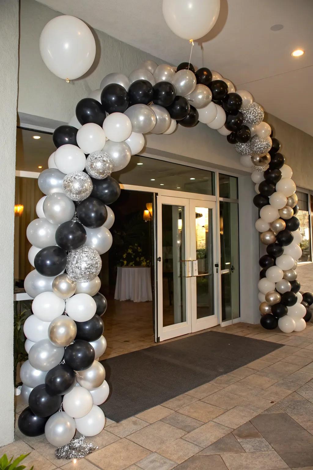 A sophisticated balloon garland in black, silver, and white.