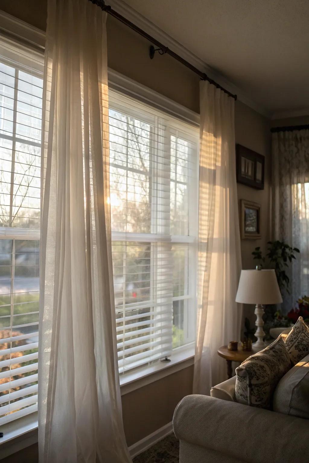 Sheer curtains over solid blinds create an elegant and soft atmosphere.