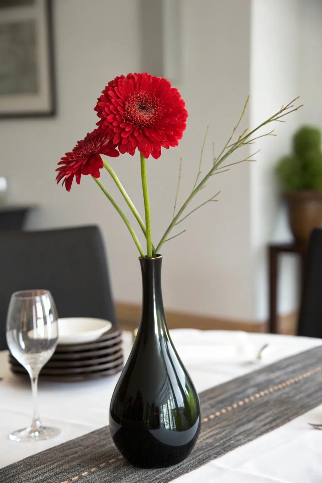 A single red bloom in a black vase for a minimalist and striking centerpiece.