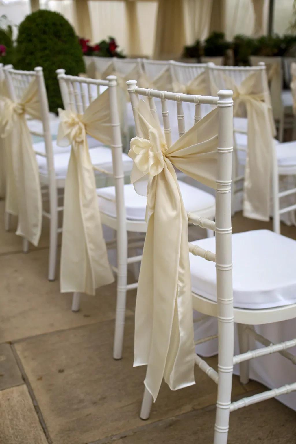 Silken ribbons append a romantic attribute to chairs.
