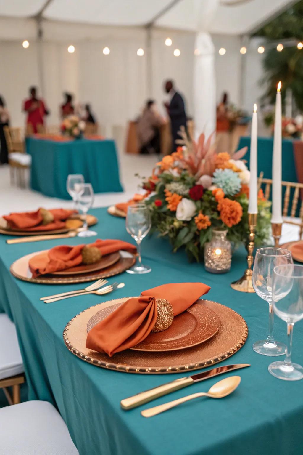 An elegant tablescape featuring teal and burnt orange.