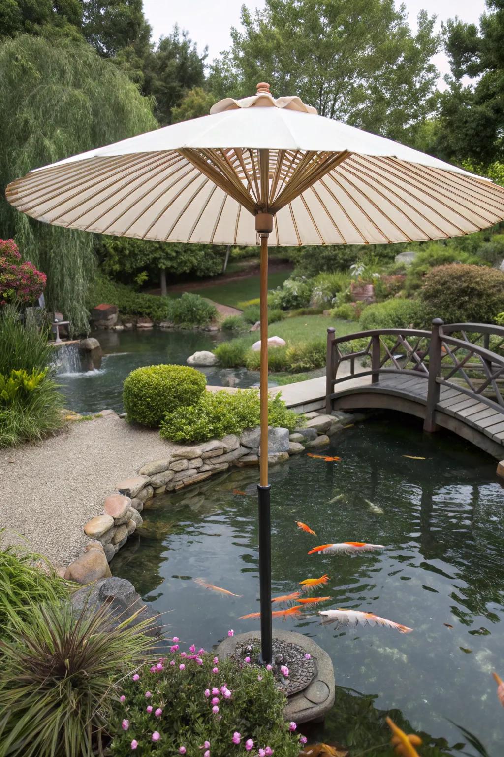 A koi pond protected by a substantial garden umbrella.