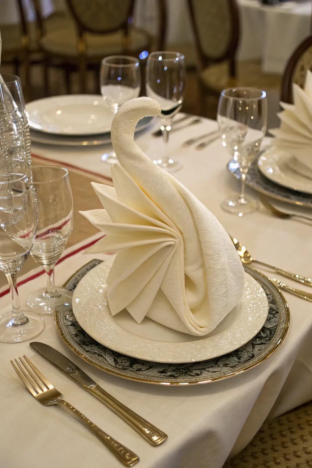 A swan shape napkin fold introduces a dash of charm to any dinner.