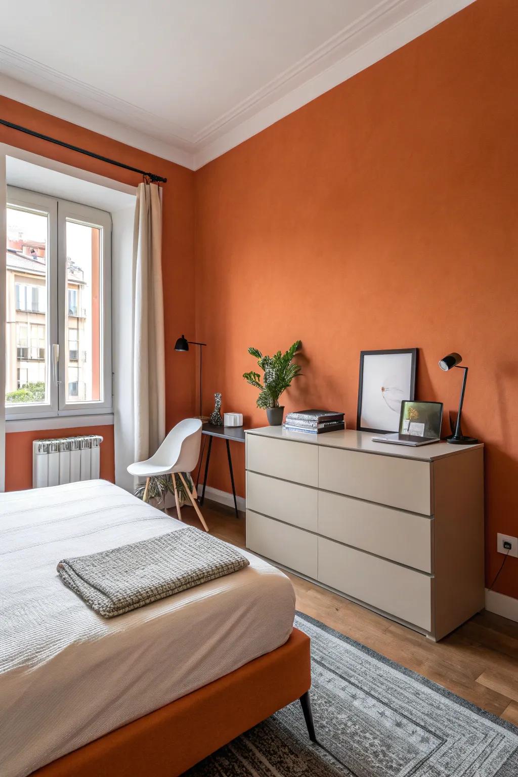 Minimalist furniture complements the boldness of orange walls.