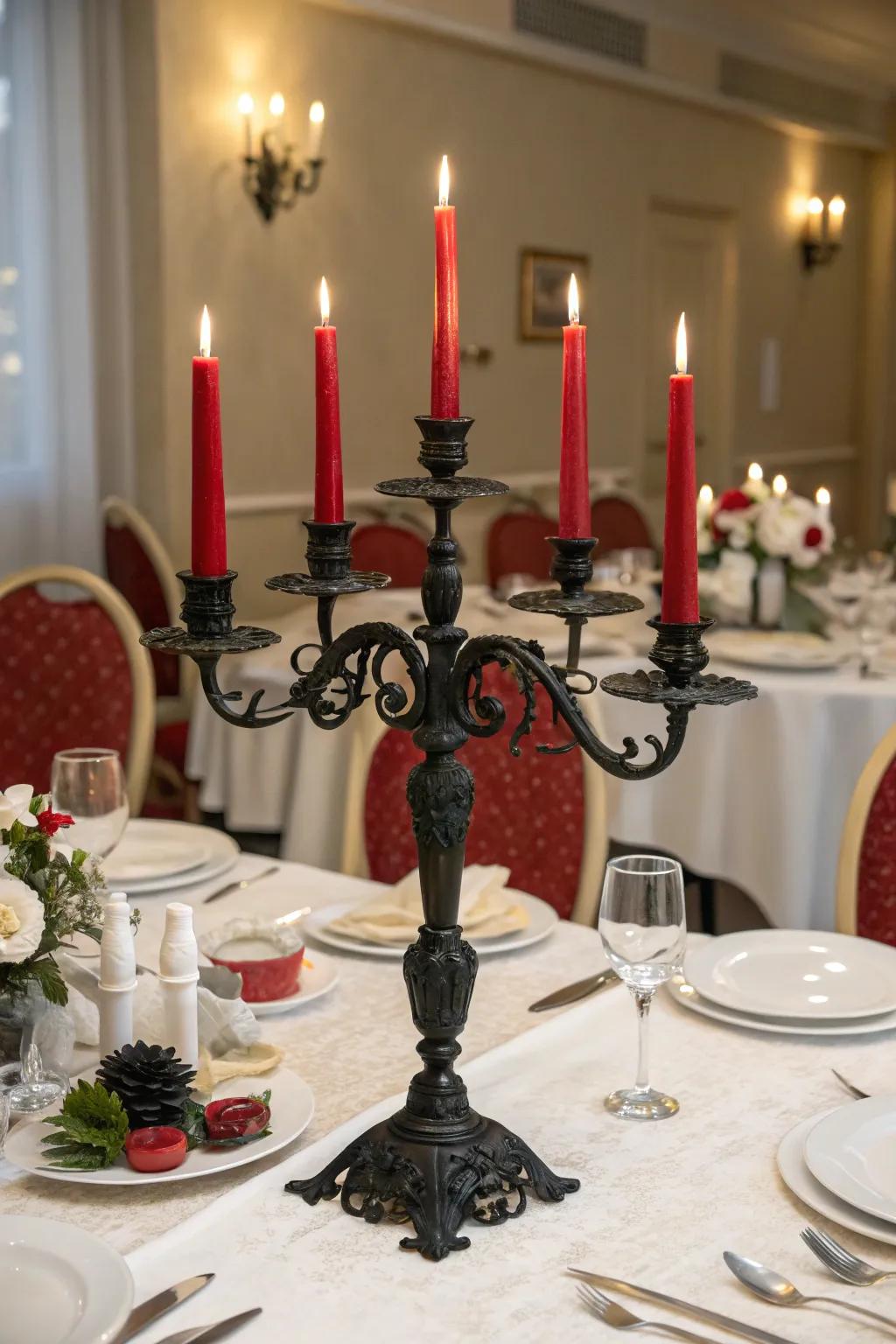 A formal dining setup with a black candelabra and red taper candles.