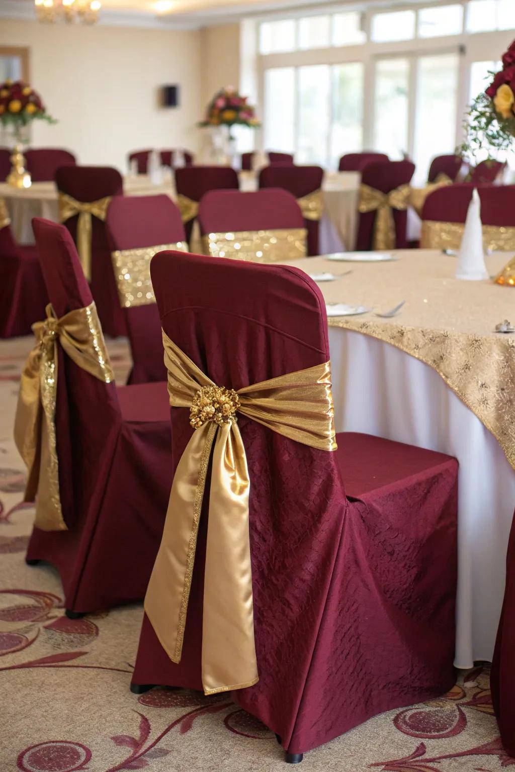 Charming chair covers in burgundy and gold add a touch of elegance to your seating.