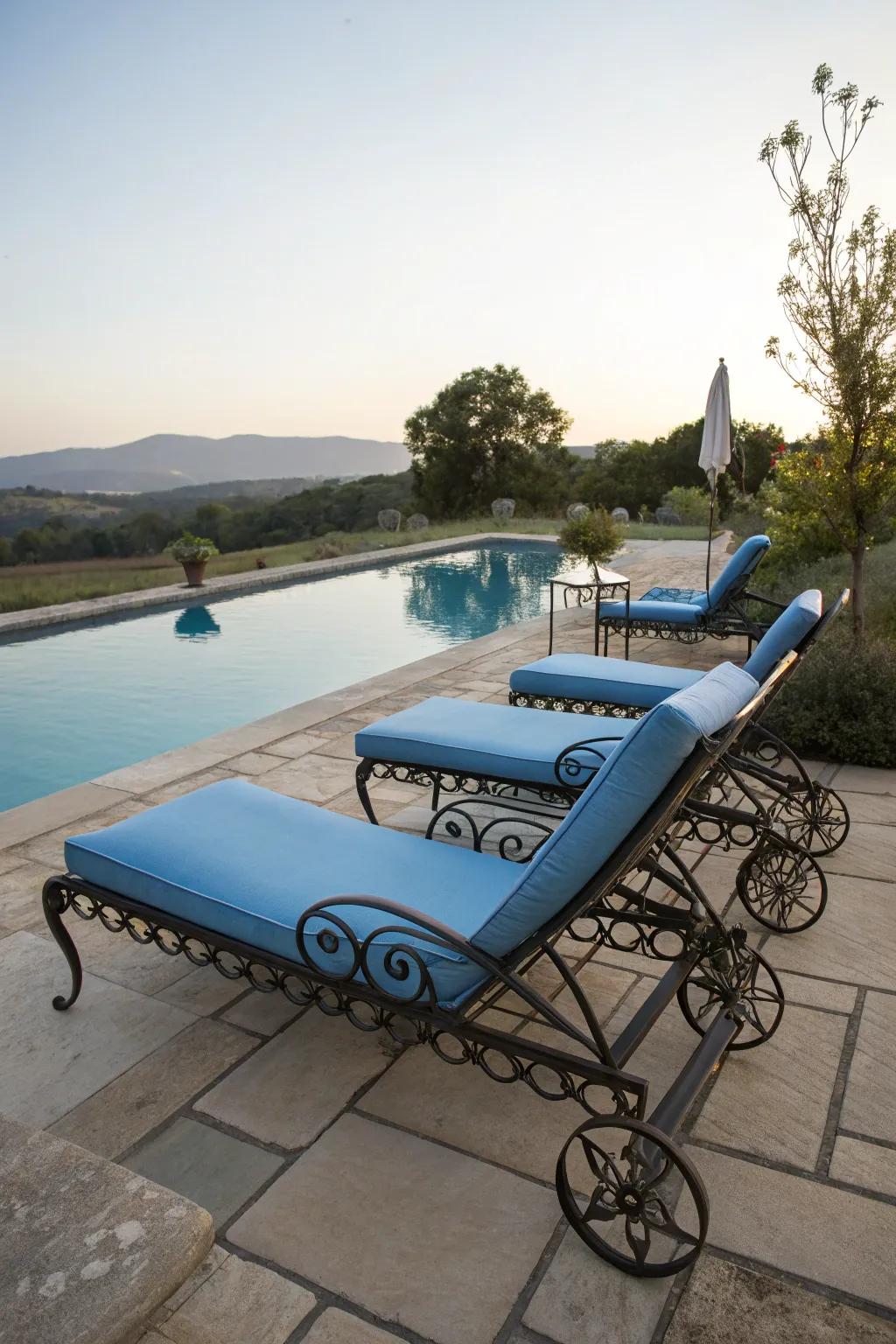 Wrought iron loungers provide stylish comfort by the pool.